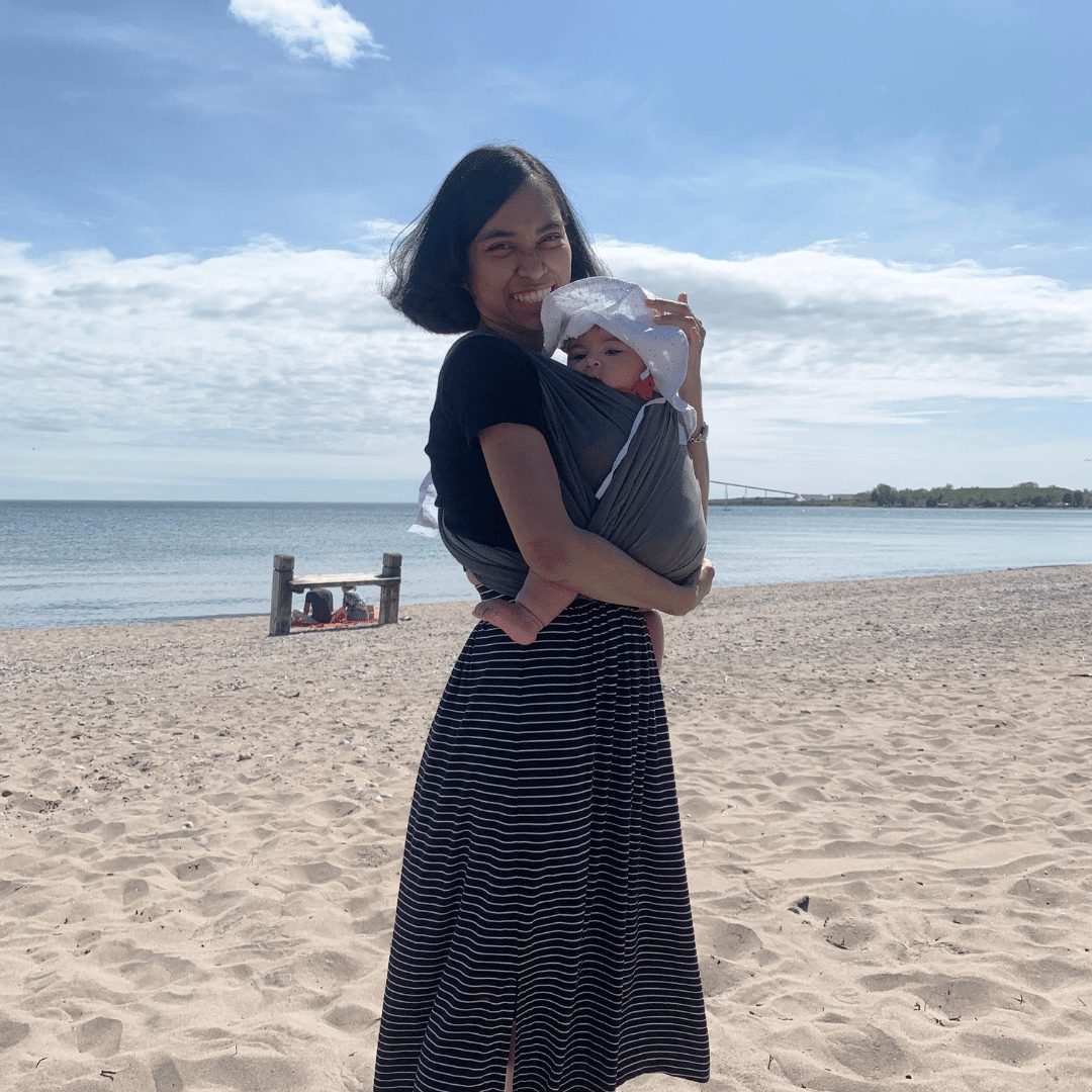 Helda holding baby at the beach